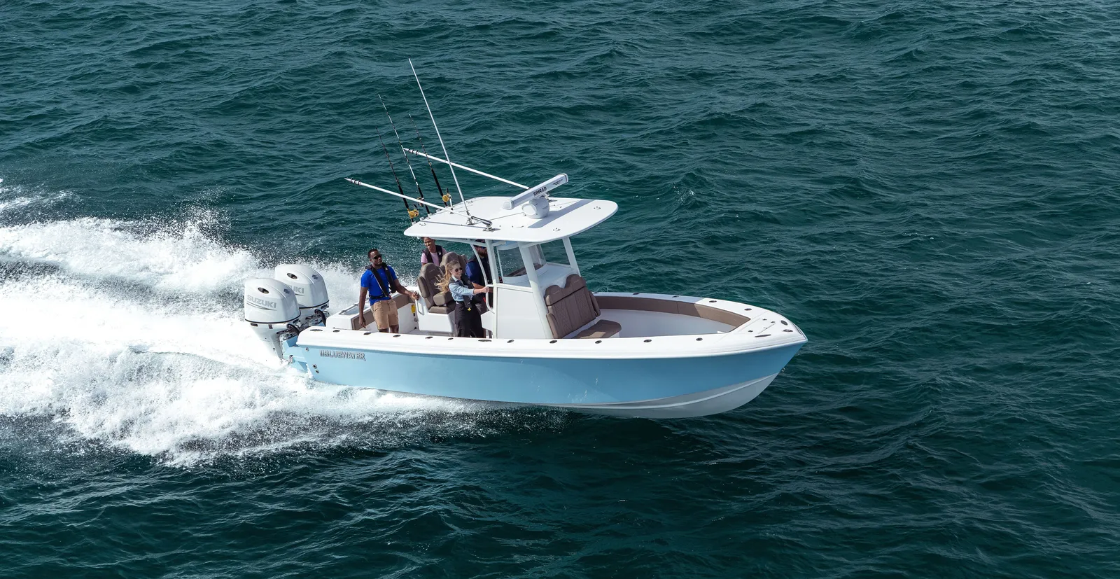 Light blue Bluewater 25T running through green water